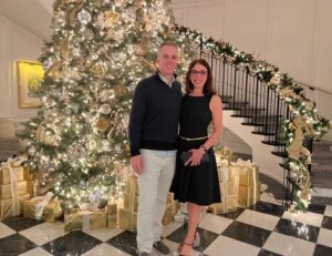 Mr and Mrs Deets in front of Christmas tree