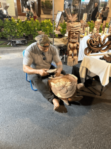 Local Hawaiian artist carving a sea turtle out of wood