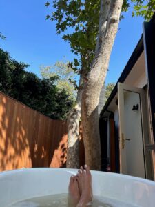 Outdoor tub with woman's feet exposed